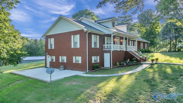 view of home's exterior with a lawn, a patio, and a porch