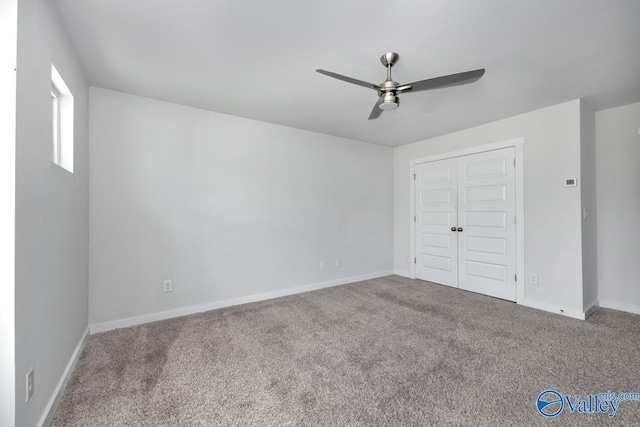 unfurnished bedroom featuring carpet floors, a closet, ceiling fan, and baseboards