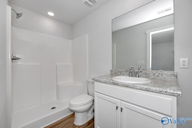 bathroom featuring toilet, a shower, and visible vents