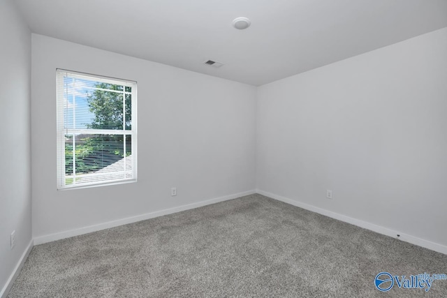 carpeted empty room with baseboards and visible vents