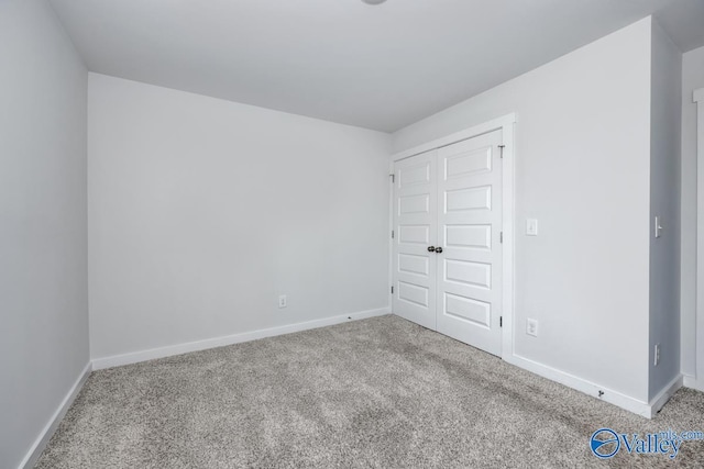 unfurnished bedroom featuring carpet flooring and baseboards