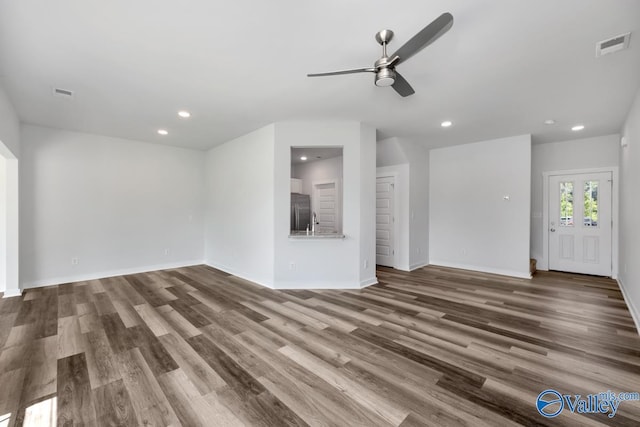 unfurnished living room with recessed lighting, visible vents, and wood finished floors