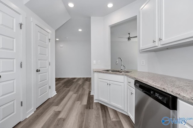 kitchen featuring a sink, white cabinets, stainless steel dishwasher, and wood finished floors