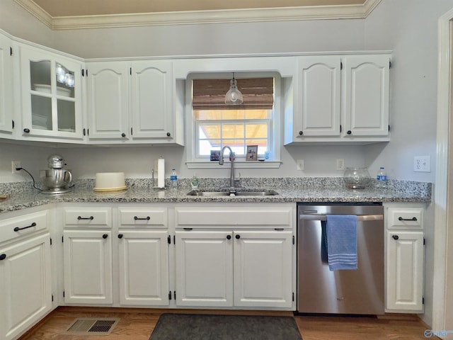 kitchen with sink, stainless steel dishwasher, crown molding, white cabinets, and hardwood / wood-style flooring