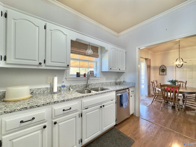 kitchen featuring dishwasher, sink, dark wood-type flooring, pendant lighting, and white cabinets