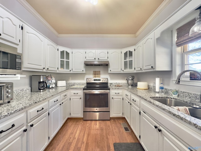 kitchen featuring white cabinetry, light wood-type flooring, and appliances with stainless steel finishes