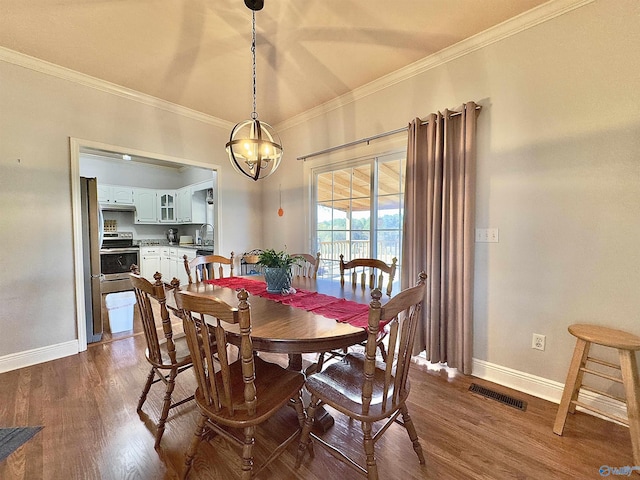 dining area with crown molding, hardwood / wood-style floors, and an inviting chandelier