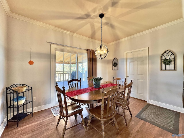 dining space with wood-type flooring, crown molding, and a chandelier