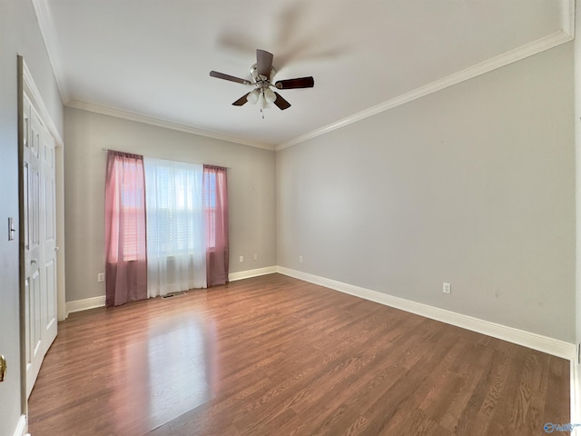 spare room with wood-type flooring and crown molding