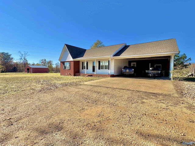 view of front of house featuring covered porch, an outbuilding, and a carport