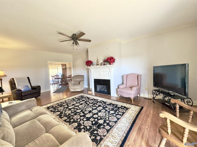 living room featuring ceiling fan, wood-type flooring, and crown molding