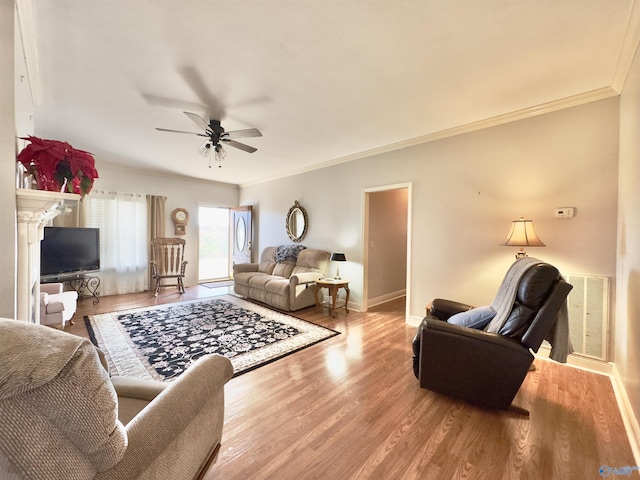 living room with ceiling fan, wood-type flooring, and crown molding