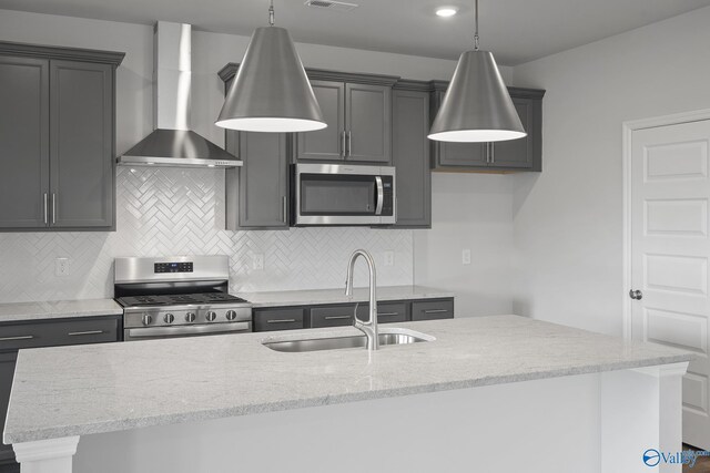 269 Shubert Dr, Hazel Green, AL 35750 - kitchen with stainless steel appliances, a sink, wall chimney range hood, an island with sink, and light stone counters