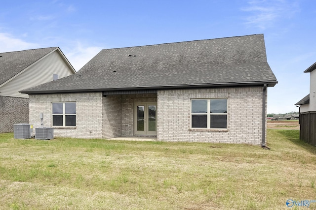 269 Shubert Dr, Hazel Green, AL 35750 - back of property with cooling unit, brick siding, a lawn, and roof with shingles