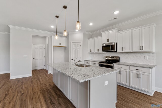 kitchen featuring stainless steel appliances, white cabinets, light stone counters, and dark hardwood / wood-style floors