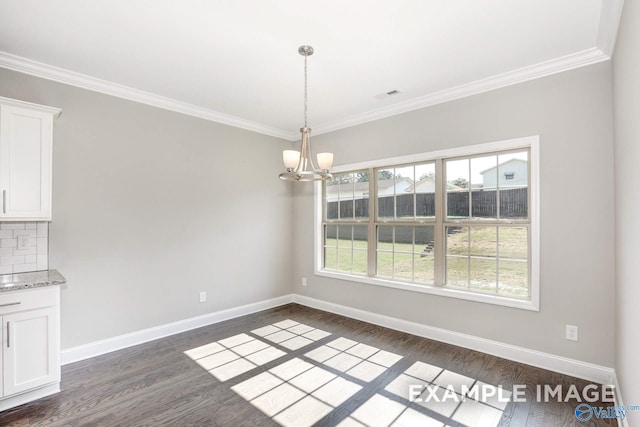 unfurnished dining area with ornamental molding, a chandelier, and dark wood-type flooring