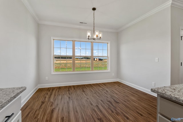 unfurnished dining area with crown molding, dark wood-style flooring, and an inviting chandelier