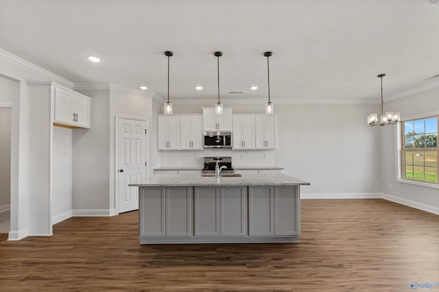 kitchen with dark wood finished floors, white cabinets, decorative backsplash, appliances with stainless steel finishes, and crown molding