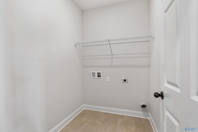 clothes washing area featuring hookup for a washing machine and hookup for an electric dryer