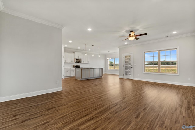 unfurnished living room with ceiling fan with notable chandelier, ornamental molding, dark wood-style flooring, and baseboards