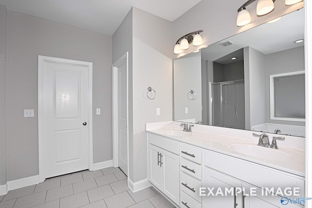 bathroom featuring tile patterned floors, an enclosed shower, and vanity