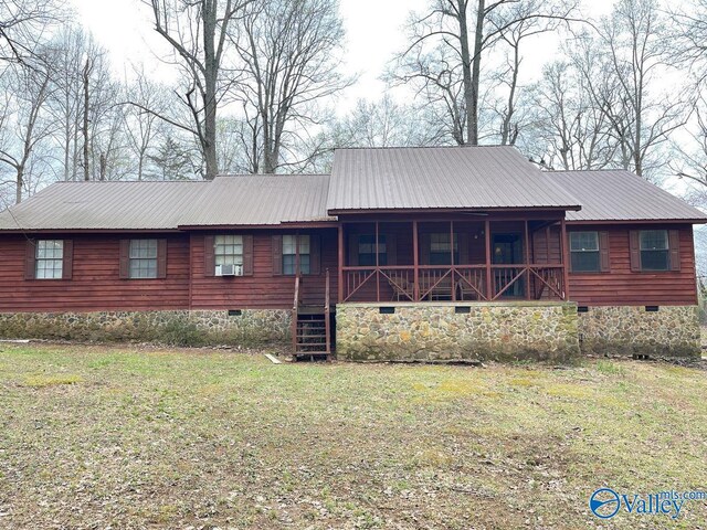 view of front of home featuring stairway, crawl space, a front yard, and metal roof