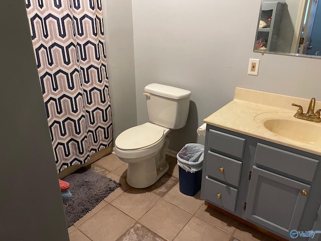 bathroom with curtained shower, tile patterned flooring, vanity, and toilet