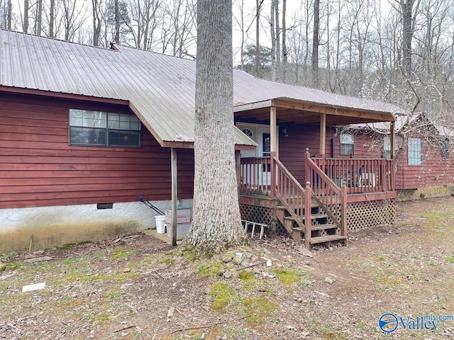 exterior space with crawl space and metal roof