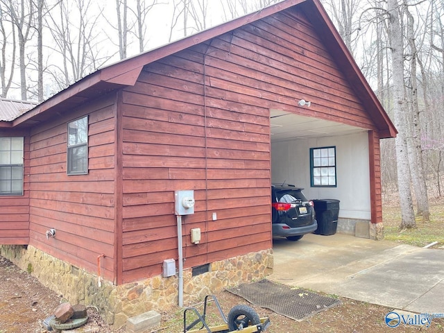 view of home's exterior with crawl space and a garage