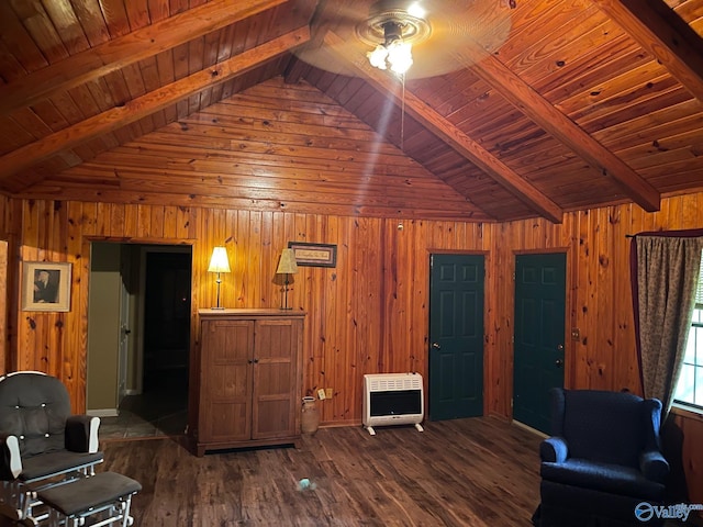 living area with wooden walls, wood ceiling, lofted ceiling with beams, and heating unit