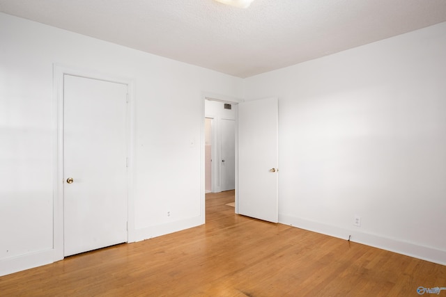 unfurnished bedroom featuring light wood-type flooring and baseboards