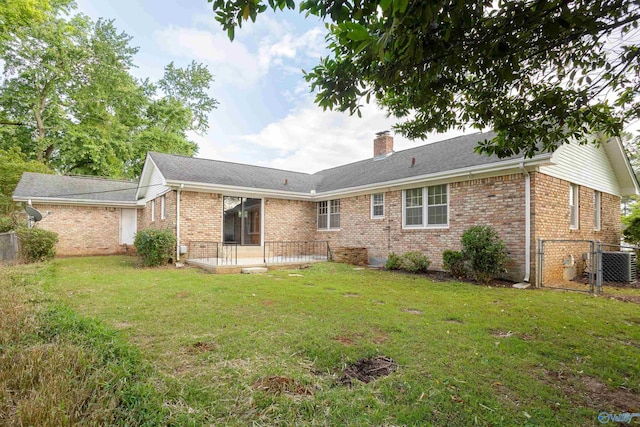 rear view of property with a gate, brick siding, a chimney, cooling unit, and roof with shingles