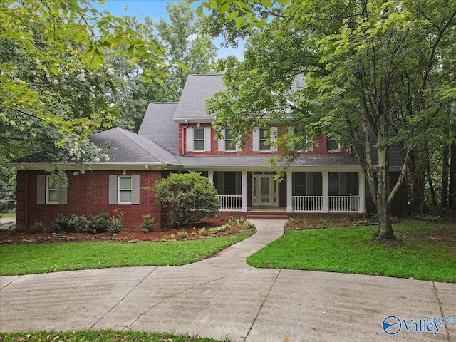 view of front of home featuring a front yard and covered porch