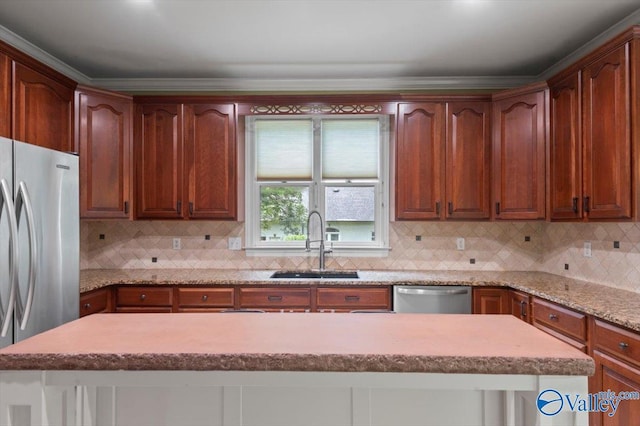 kitchen featuring sink, a kitchen island, stainless steel appliances, light stone countertops, and backsplash