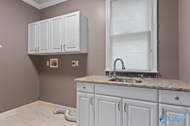 clothes washing area featuring sink, crown molding, electric dryer hookup, hookup for a washing machine, and cabinets