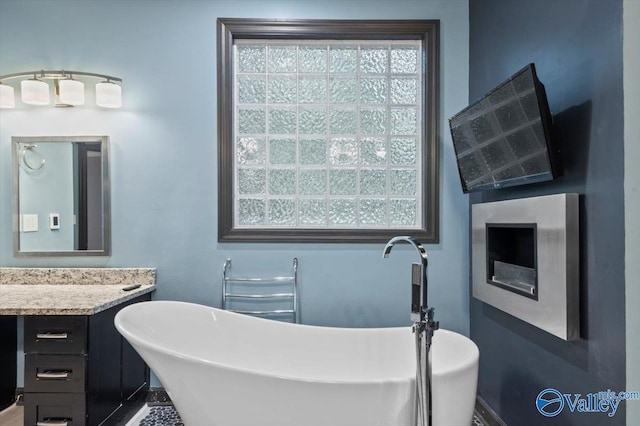 bathroom with vanity and a tub