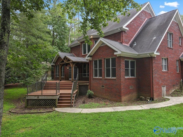 view of front facade with a front yard and a deck