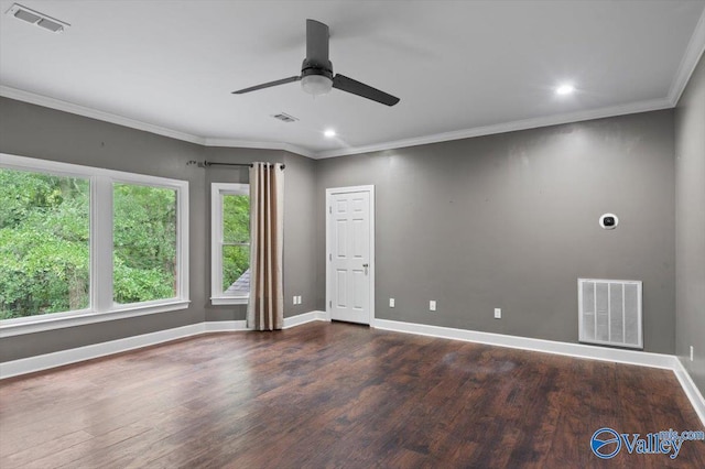 empty room featuring dark hardwood / wood-style flooring, ornamental molding, and ceiling fan