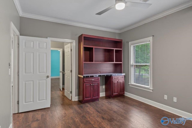 unfurnished office featuring ceiling fan, ornamental molding, dark hardwood / wood-style floors, and built in desk