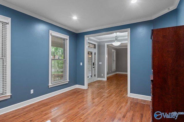 unfurnished room featuring hardwood / wood-style floors and crown molding