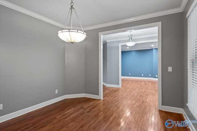 unfurnished dining area featuring crown molding and wood-type flooring