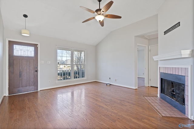 unfurnished living room featuring lofted ceiling, dark wood-type flooring, and ceiling fan