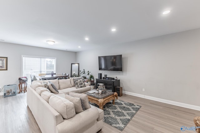 living area with light wood finished floors, baseboards, and recessed lighting