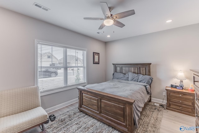 bedroom featuring light wood-style flooring, visible vents, baseboards, and recessed lighting