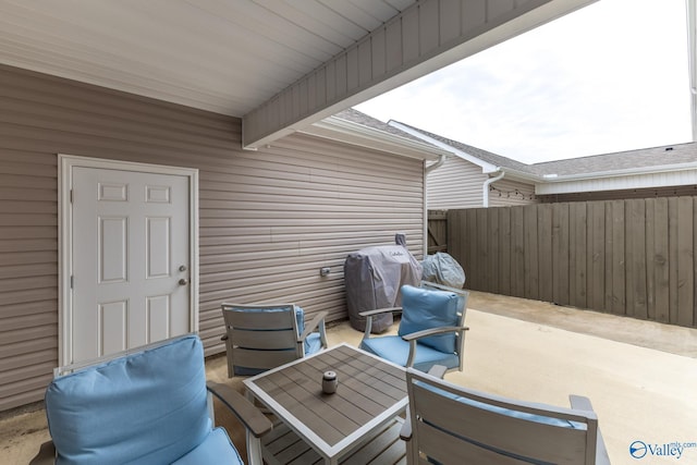 view of patio / terrace with a grill and fence