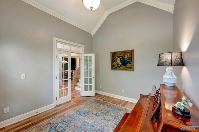 interior space with stairway, baseboards, ornamental molding, wood finished floors, and high vaulted ceiling