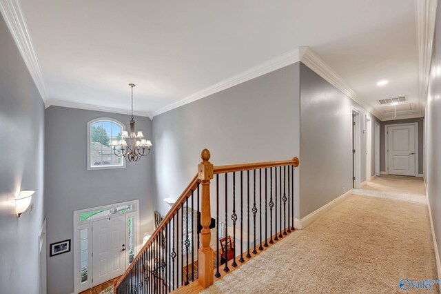corridor featuring carpet, attic access, baseboards, visible vents, and crown molding