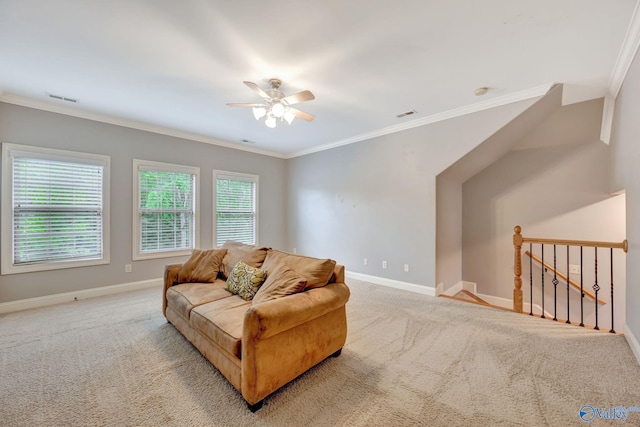 carpeted living area featuring crown molding, visible vents, and baseboards