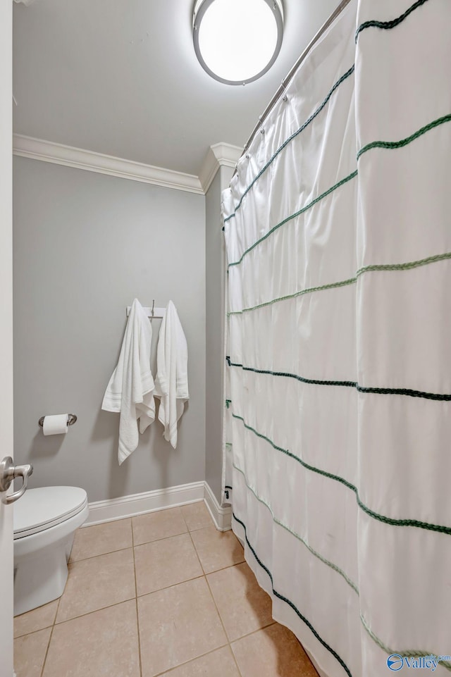 bathroom featuring crown molding, a shower with curtain, baseboards, toilet, and tile patterned floors