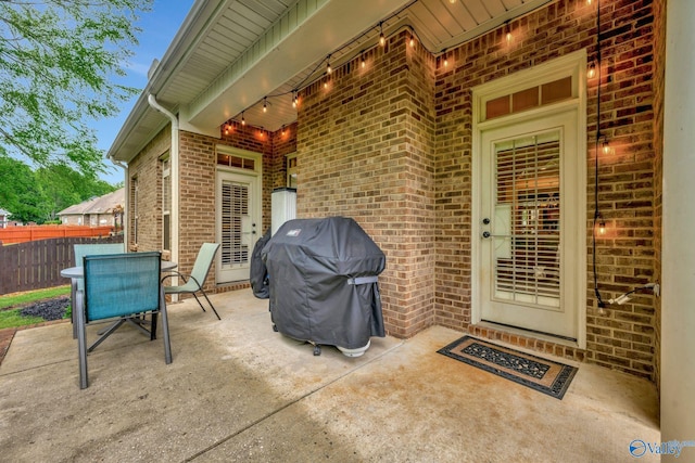 view of patio / terrace with fence, grilling area, and outdoor dining area